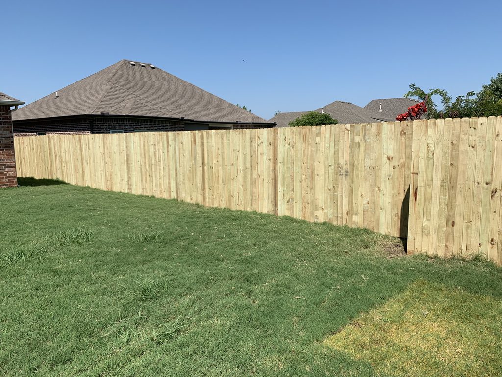Wood privacy fence enclosing a residential backyard.